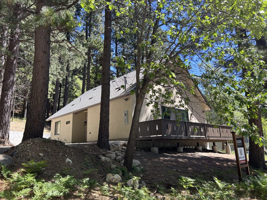 Clubhouse exterior and deck surrounded by trees